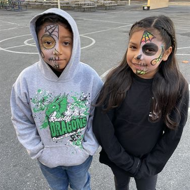 2 students with Day of the Dead facepaint
